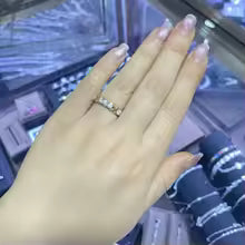 A dazzling gold and silver color-blocked cross ring