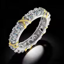 A dazzling gold and silver color-blocked cross ring