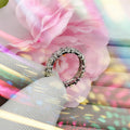 A dazzling gold and silver color-blocked cross ring