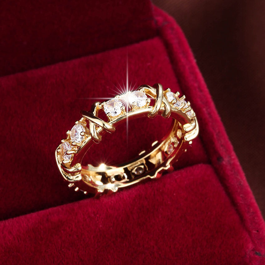 A dazzling gold and silver color-blocked cross ring